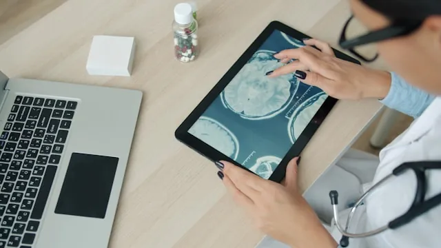 Clinician reviewing medical imaging on a tablet